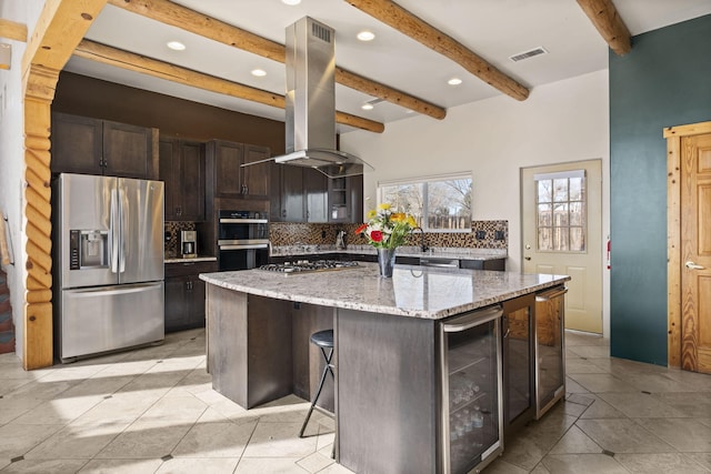 kitchen with tasteful backsplash, visible vents, wine cooler, island exhaust hood, and stainless steel appliances