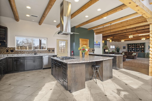 kitchen featuring stainless steel appliances, a sink, a large island, light stone countertops, and island exhaust hood