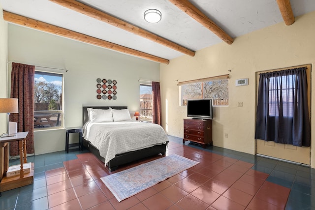 tiled bedroom with multiple windows and beam ceiling