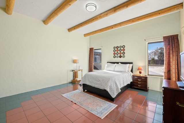 bedroom featuring dark tile patterned flooring and beam ceiling