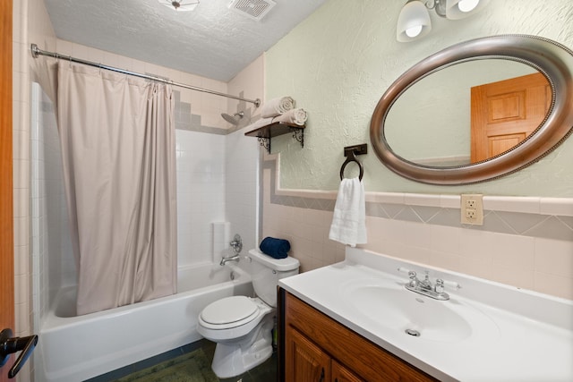 full bath with tile walls, visible vents, a textured wall, shower / bath combo, and a textured ceiling