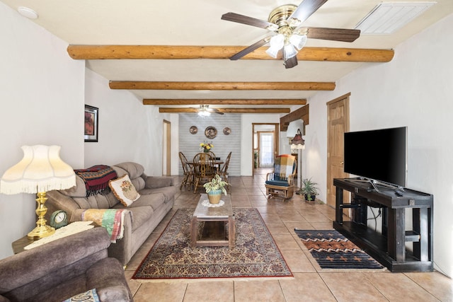 living area featuring visible vents, beamed ceiling, a ceiling fan, and tile patterned floors