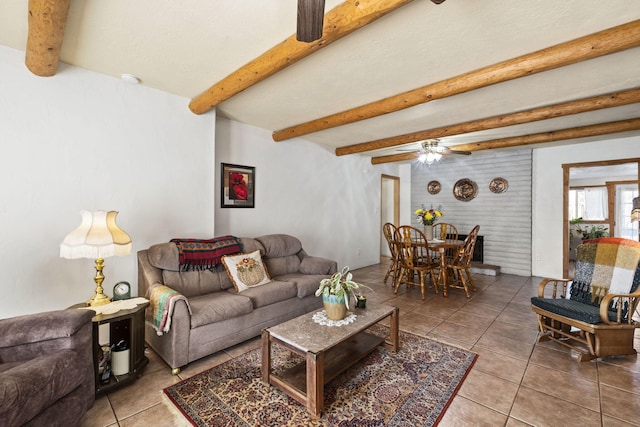 tiled living room featuring ceiling fan and beam ceiling