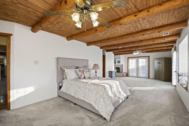 bedroom featuring visible vents, wooden ceiling, a lit fireplace, carpet floors, and beam ceiling