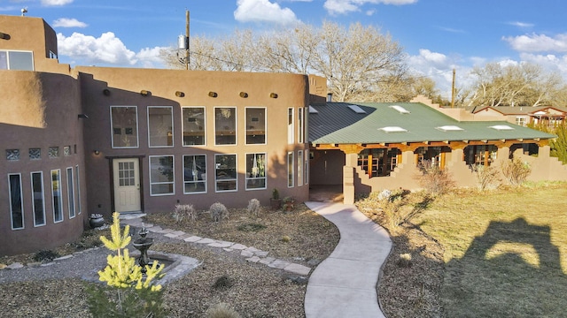 back of house featuring stucco siding