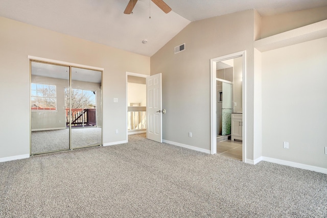 unfurnished bedroom with visible vents, baseboards, vaulted ceiling, a closet, and carpet