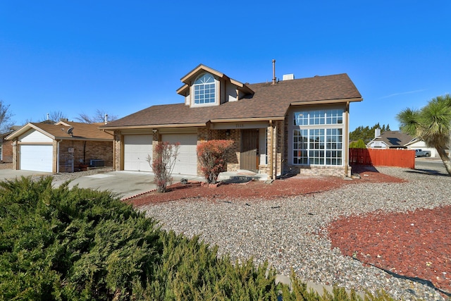 view of front of property featuring central AC unit, concrete driveway, an attached garage, fence, and brick siding