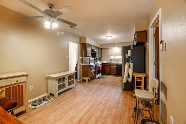 kitchen with visible vents, stainless steel appliances, a textured ceiling, light countertops, and light wood-type flooring