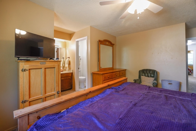 bedroom with a textured ceiling, connected bathroom, and a ceiling fan