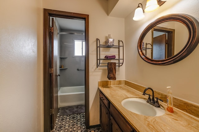 full bath with washtub / shower combination, tile patterned flooring, and vanity