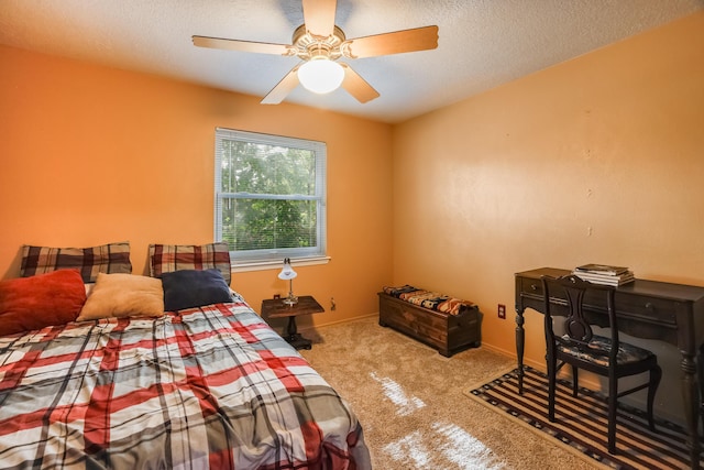 carpeted bedroom featuring ceiling fan, baseboards, and a textured ceiling