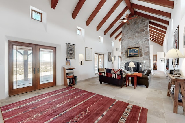 living area with ceiling fan, high vaulted ceiling, a stone fireplace, french doors, and beam ceiling