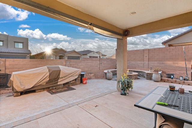 view of patio featuring an outdoor fire pit and a fenced backyard