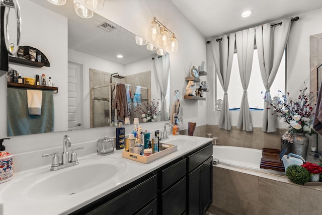 bathroom with double vanity, a sink, visible vents, and a shower stall