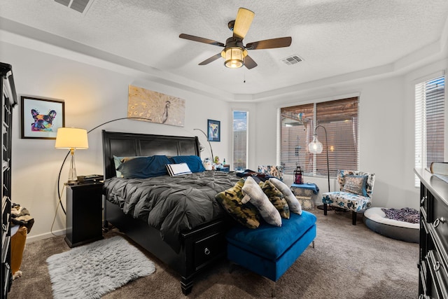 bedroom featuring a textured ceiling, visible vents, and carpet flooring