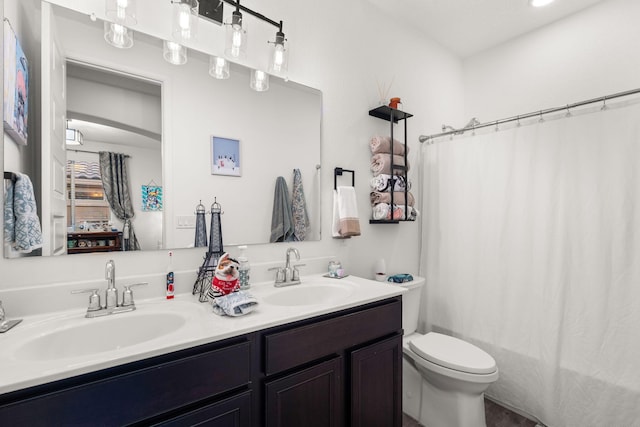 full bath with toilet, double vanity, a sink, and shower / tub combo with curtain