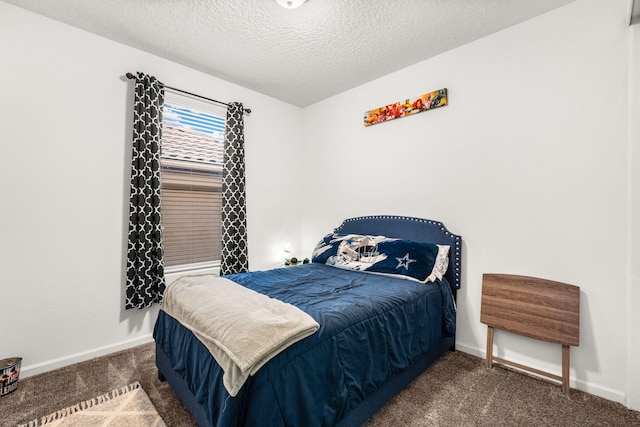 carpeted bedroom with baseboards and a textured ceiling