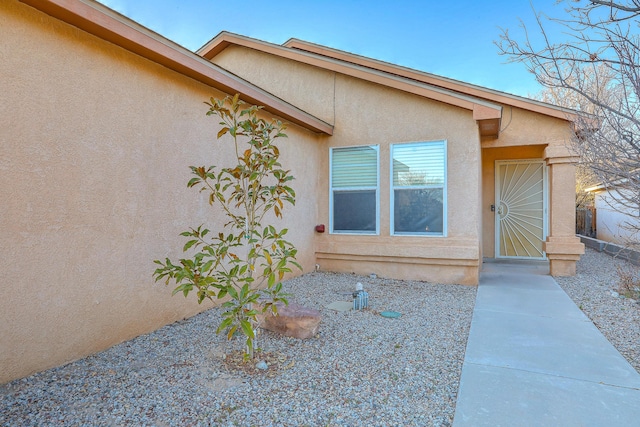 doorway to property with stucco siding