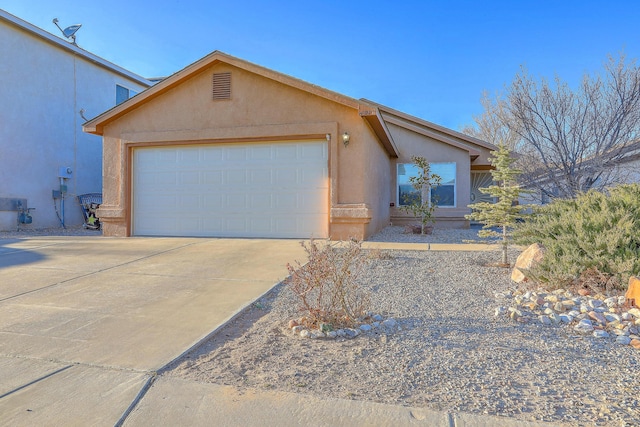 view of front of property with a garage, driveway, and stucco siding