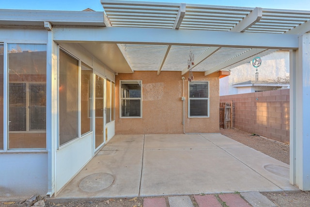 view of patio with fence, a sunroom, and a pergola