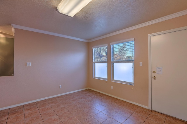 spare room featuring light tile patterned floors, a textured ceiling, baseboards, and crown molding