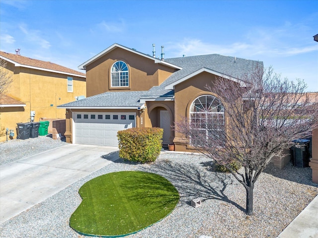 traditional-style house with driveway, roof with shingles, a garage, and stucco siding