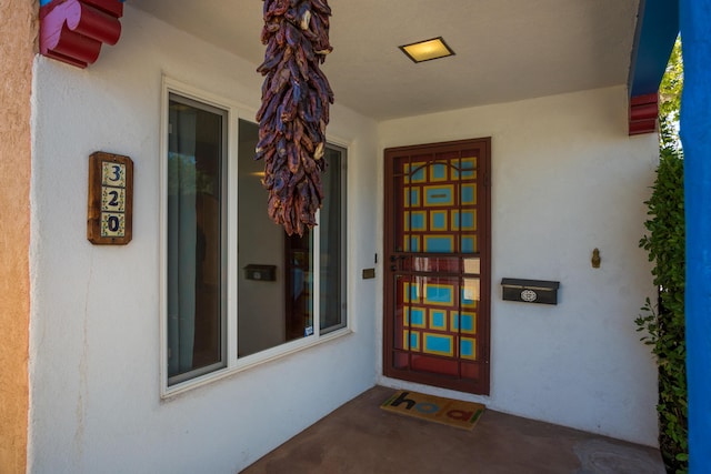 property entrance with stucco siding