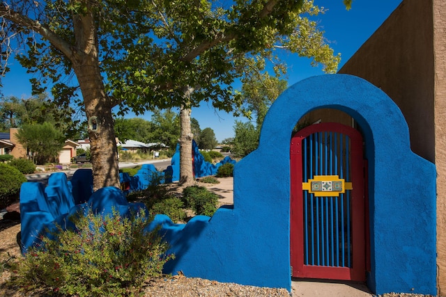 view of side of property featuring a gate and stucco siding