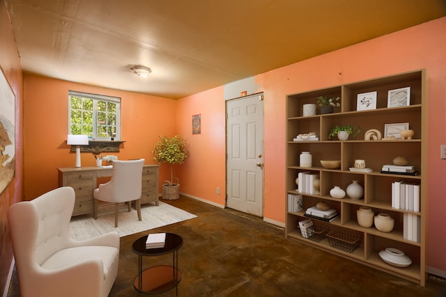 home office with concrete floors and baseboards