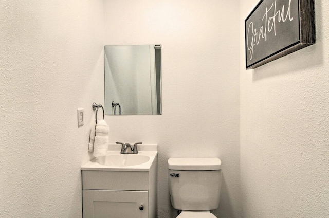 half bath with toilet and vanity