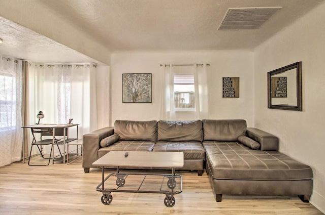 living room with wood finished floors and visible vents