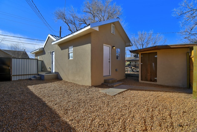 view of side of property featuring stucco siding