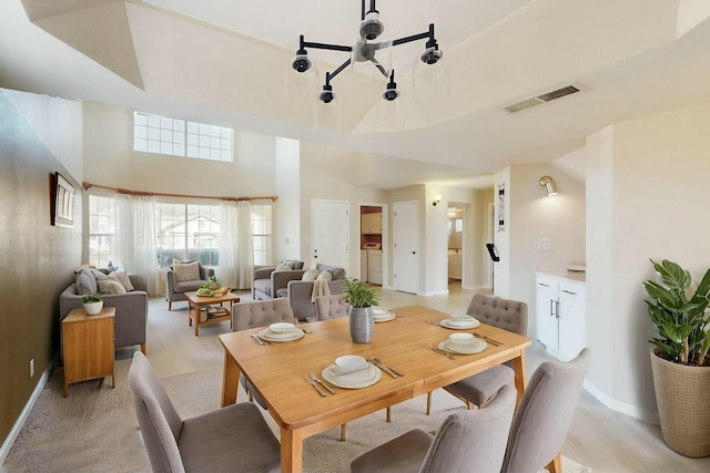 dining area featuring washer and clothes dryer, visible vents, and baseboards