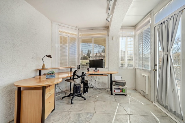 office area featuring a textured wall and track lighting