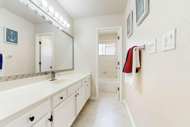 bathroom featuring baseboards, a shower, tile patterned floors, a bathtub, and vanity