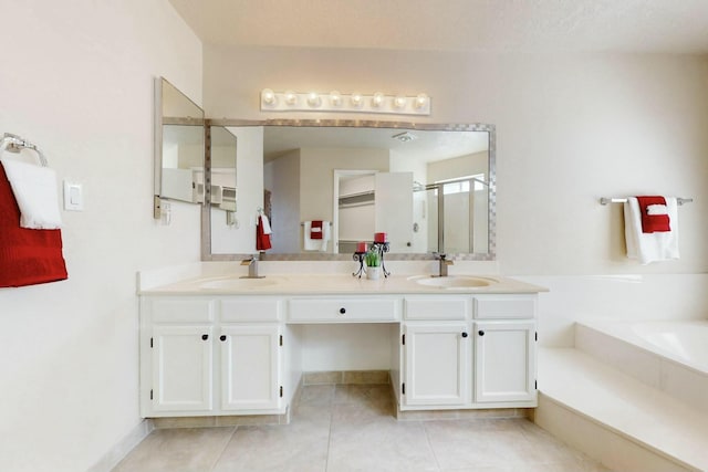 bathroom featuring double vanity, tile patterned flooring, a sink, and a shower stall