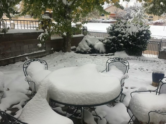 yard layered in snow with fence