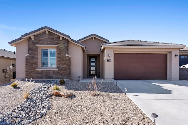 view of front facade with an attached garage, a tile roof, driveway, stone siding, and stucco siding