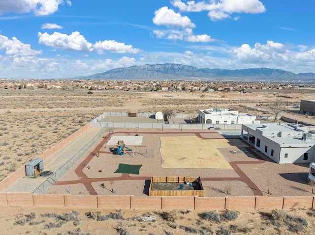 birds eye view of property featuring a mountain view and a desert view