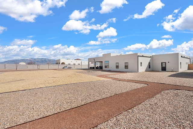 back of house featuring a patio area, a fenced backyard, and stucco siding