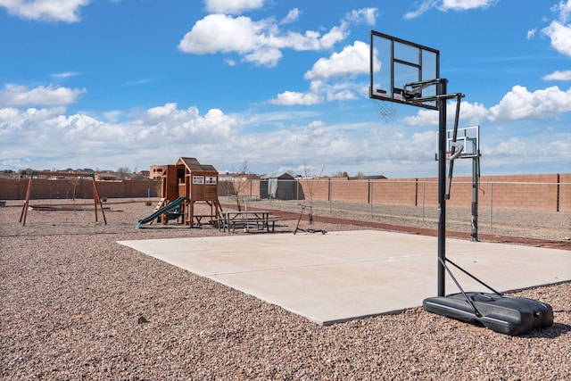 view of basketball court with community basketball court, playground community, and fence