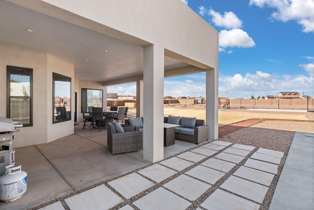 view of patio / terrace featuring fence, an outdoor hangout area, and outdoor dining space