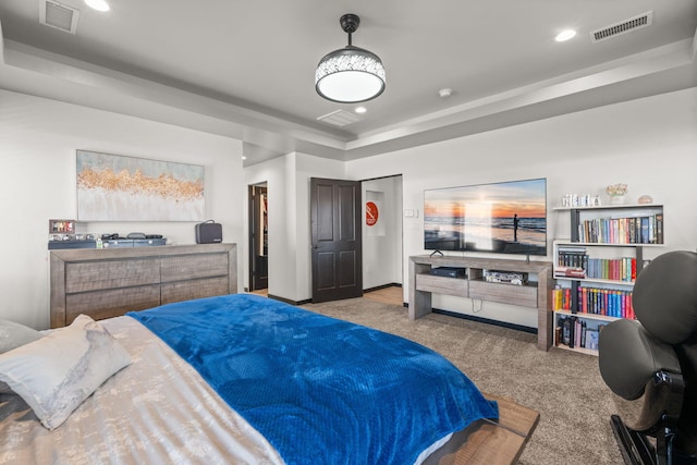 carpeted bedroom featuring recessed lighting, a raised ceiling, and visible vents