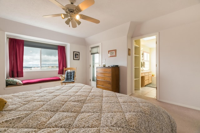 carpeted bedroom with multiple windows, baseboards, connected bathroom, and a ceiling fan