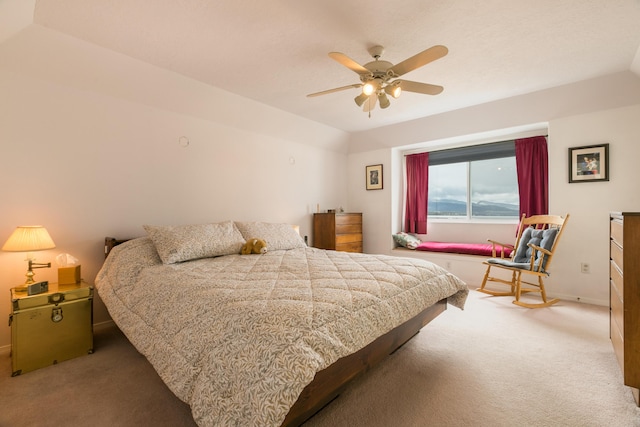 carpeted bedroom featuring baseboards, lofted ceiling, and ceiling fan