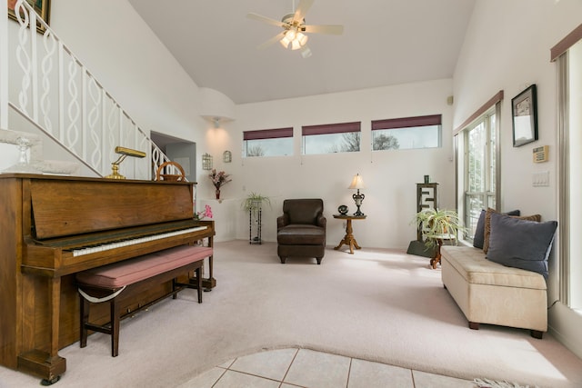 living area featuring a wealth of natural light, carpet floors, high vaulted ceiling, and ceiling fan