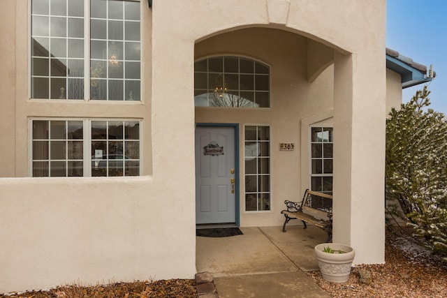 entrance to property featuring stucco siding