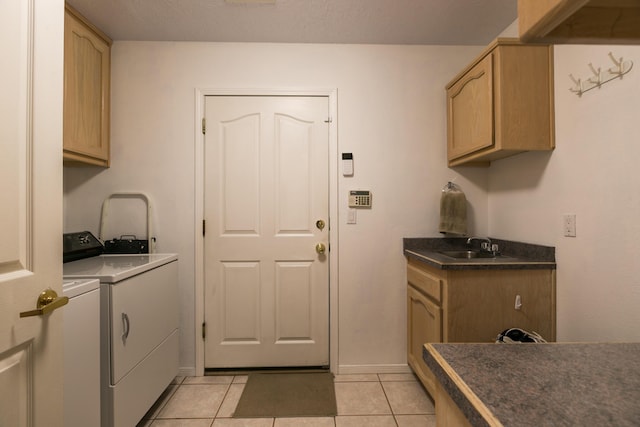 laundry room with independent washer and dryer, a sink, cabinet space, light tile patterned floors, and baseboards