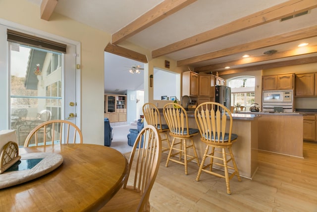 dining room featuring light wood finished floors, visible vents, ceiling fan, beam ceiling, and recessed lighting