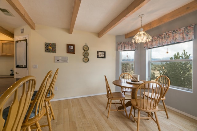 dining room with visible vents, light wood-style flooring, and baseboards